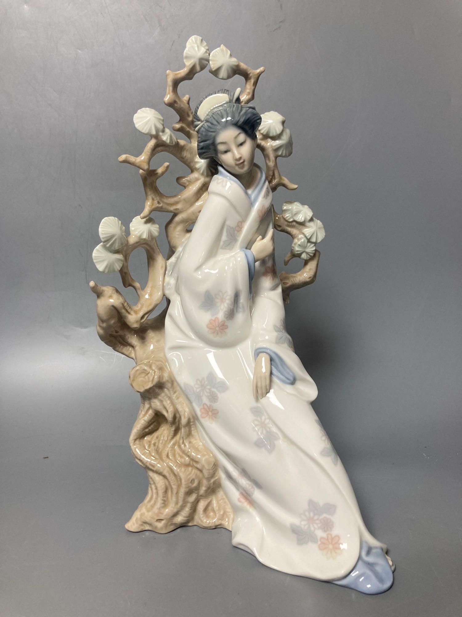 A Lladro figure of a geisha, 30cm high and another of a seagull, 29cm high and a Nao figure of a baby, length 21cm
